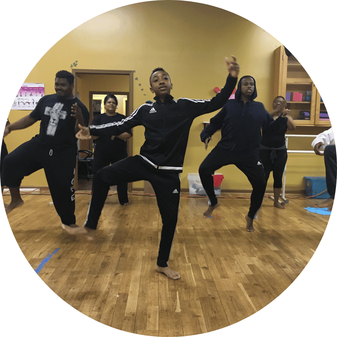 A diverse group of individuals participating in a lively dance class, showcasing various dance styles and movements.